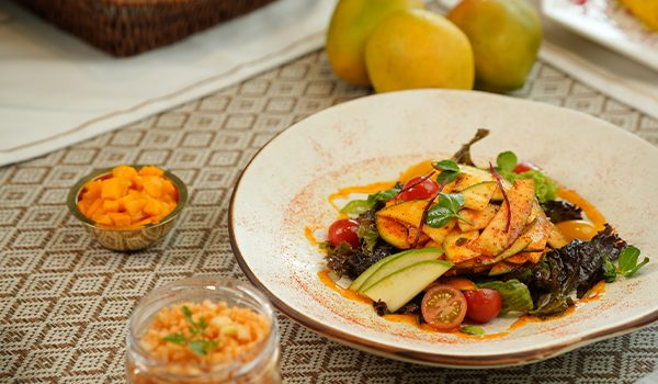 Chef plating a signature vegetarian creation